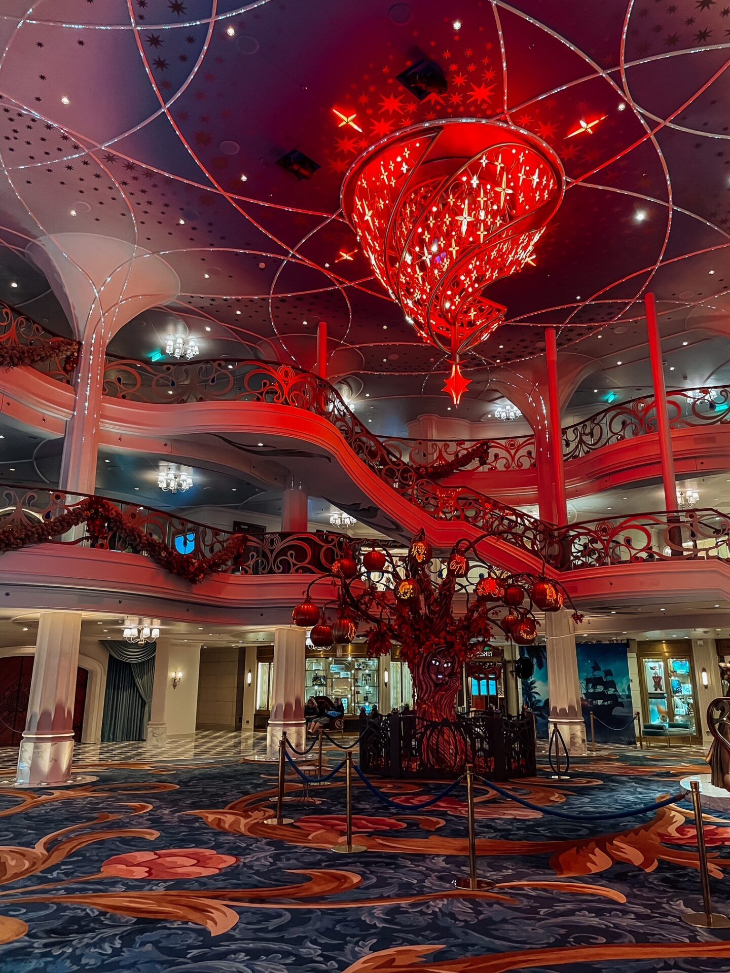 Disney Wish atrium lit up at night during Pirate Night 